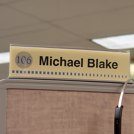 Cubicle nameplate installed above a cubicle panel for easy identification in an office workspace