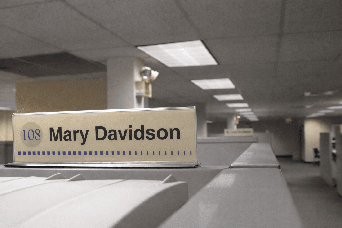 Cubicle nameplate signage mounted on office workstation