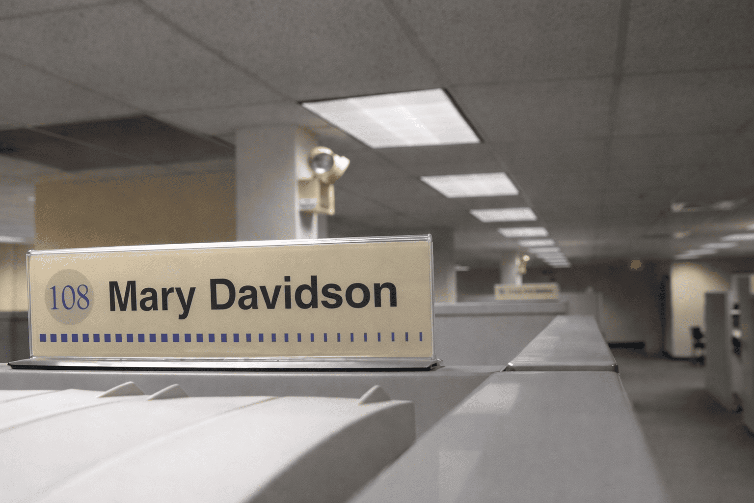 Cubicle nameplate signage mounted on office workstation
