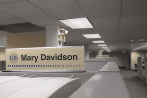 Cubicle nameplate signage mounted on office workstation